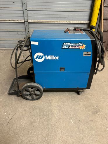 Blue Millermatic 212 Auto-Set welding machine on wheels.