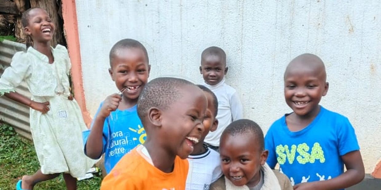A group of happy children laughing and enjoying together outdoors.