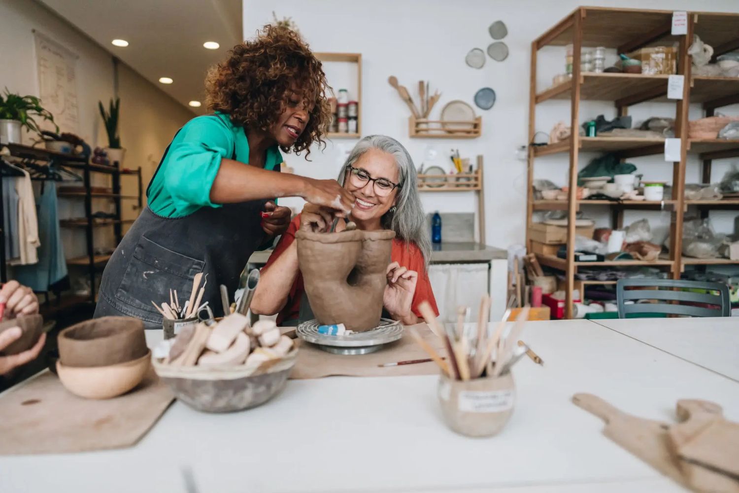 Two women working together in a creative space.