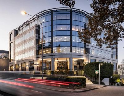 Modern glass office building at dusk.