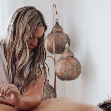 Massage therapist gives relaxing massage to lower back