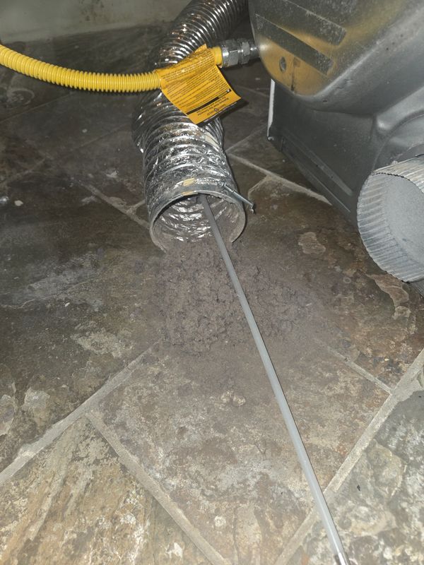 Rupert Richardson owner of Rupert LCS cleaning a residential dryer vent in Essex County NJ