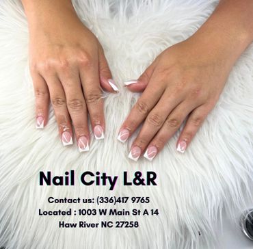 Elegant white-tipped French manicure on well-groomed hands.