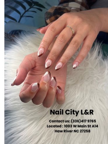 Stylish brown and white geometric nail art on manicured hands with rings.