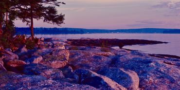Island rocks suffused with dawn light looking towards Muscongus
