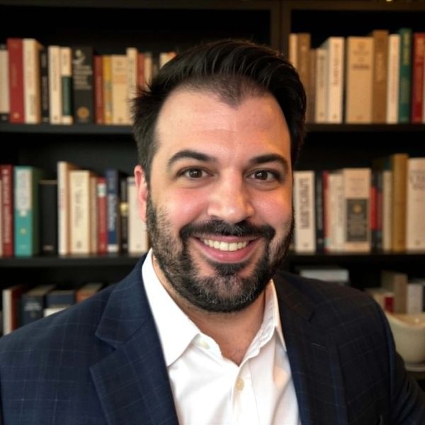 Themis Zanidis in an office with a library background