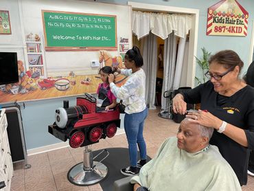 Sylvia getting her first hair cut during her cancer treatment