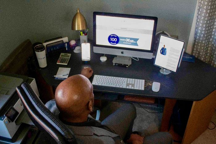 CEO & Principal Broker at Dunlap Financial Services sitting at his desk in his home office.
