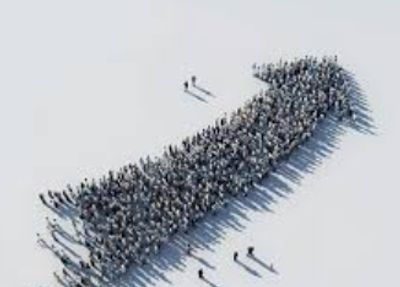 Large crowd forming a right-pointing arrow shape on a plain background.