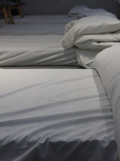 Night shelter beds all made up with fresh white sheets