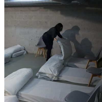 One of our volunteers making up beds