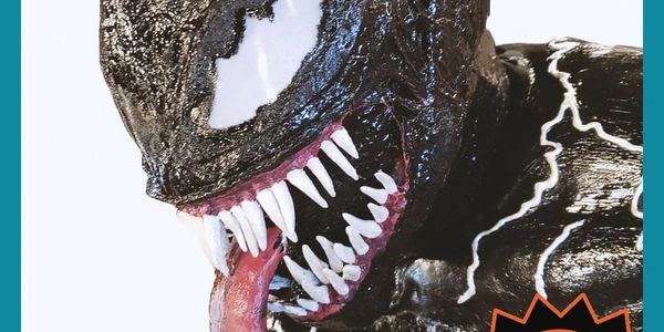 Close-up of Venom's menacing face with sharp teeth and tongue.