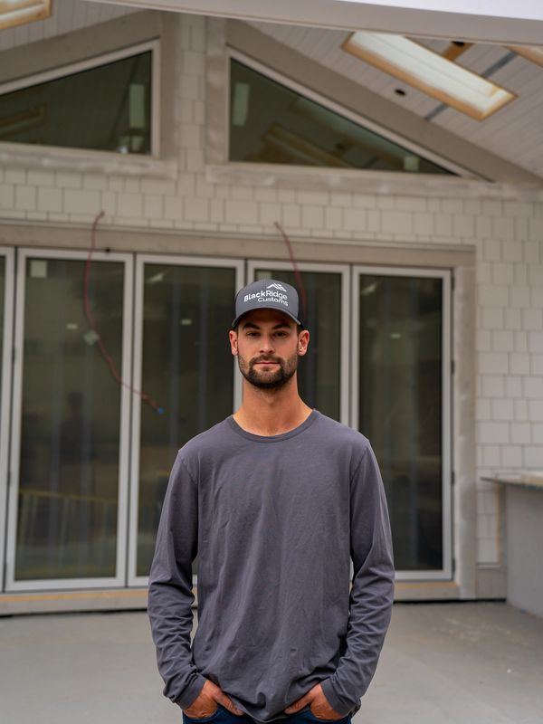 Man wearing a BlackRidge Customs cap and gray long-sleeve shirt.