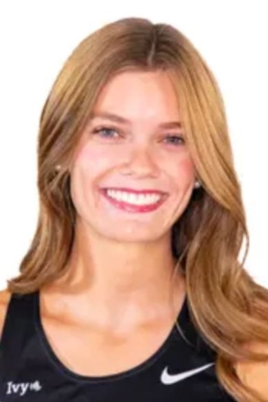 Smiling young woman with blonde hair in a black Nike tank top.