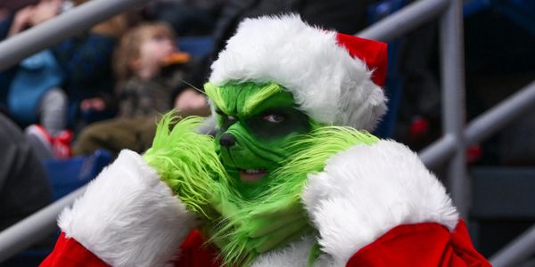 Person dressed as the Grinch in Santa costume.