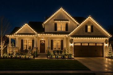 House decorated with warm white Christmas lights at night.