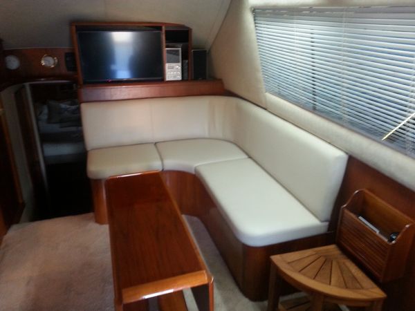 Interior, specialized, vinyl yacht upholstery for a corner booth with multiple pieces on the water.