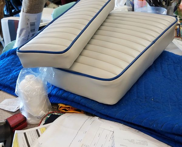 white and blue-trimmed marine arm rest and seat cushioning. marine upholstery done right