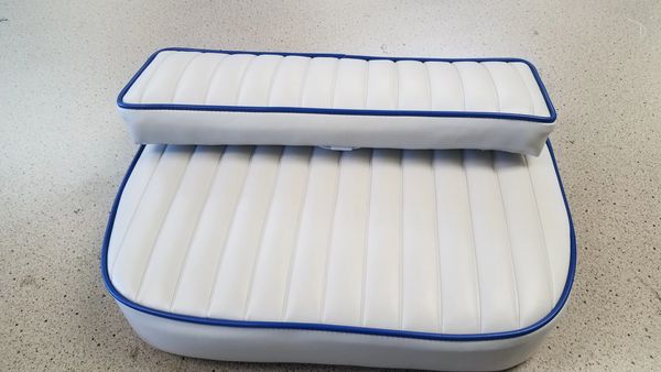Stacked Blue and white cushion that clips onto boat.