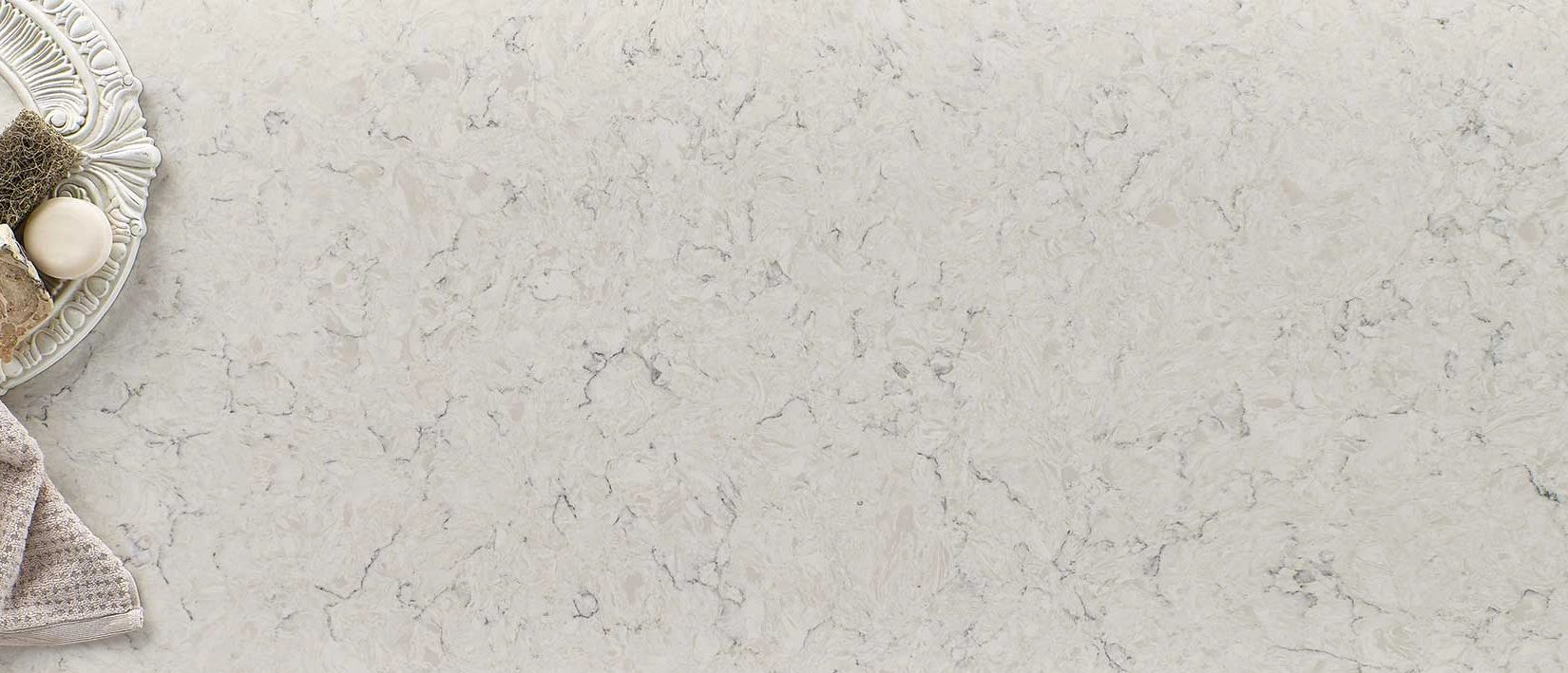 Carrara mist, creamy background highlighted with subtle specks and veins that add interest and depth