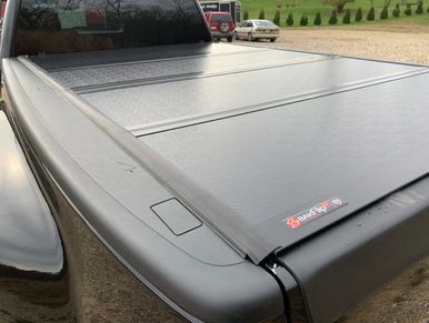 Black pickup truck with a BakFlip truck bed cover.