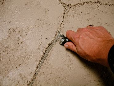 decorative stonework design process with hand in frame