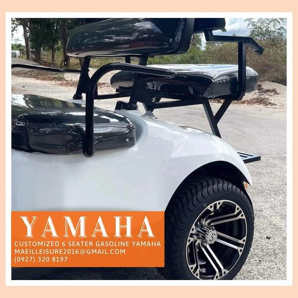 Customized 6-seater gasoline Yamaha golf cart with sleek black seats and stylish rims.