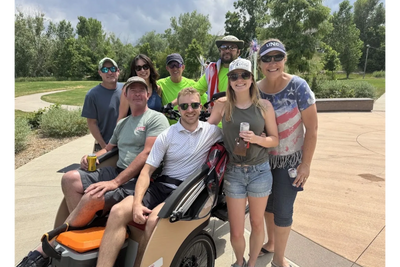 Multi-generational family enjoying a free Trishaw ride with Cycling without Age Littleton.