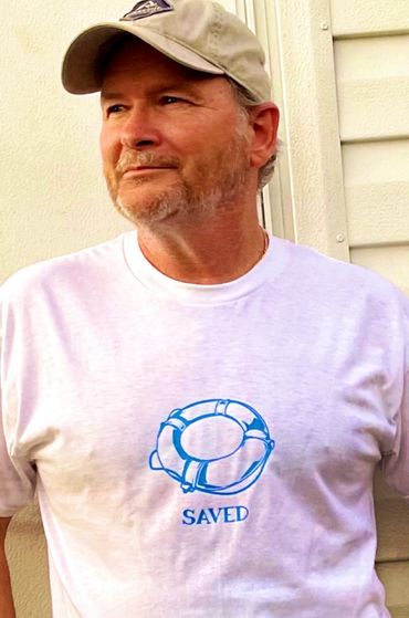 White tee with blue letters.