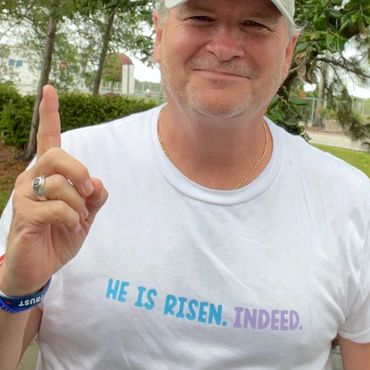 White tee with blue and lavender type.