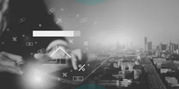 Black and white image of hands interacting with digital charts over a cityscape.