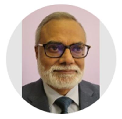 Portrait of an elderly man with glasses and a beard, wearing a suit and tie.