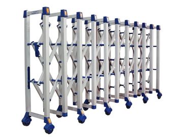 A collapsible metal security barrier with blue wheels and handles.