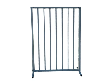 A metal barricade panel with vertical bars and feet for stability.