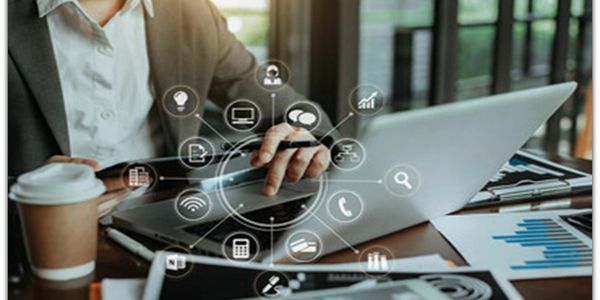 Person using a smartphone and laptop with digital business icons overlay.