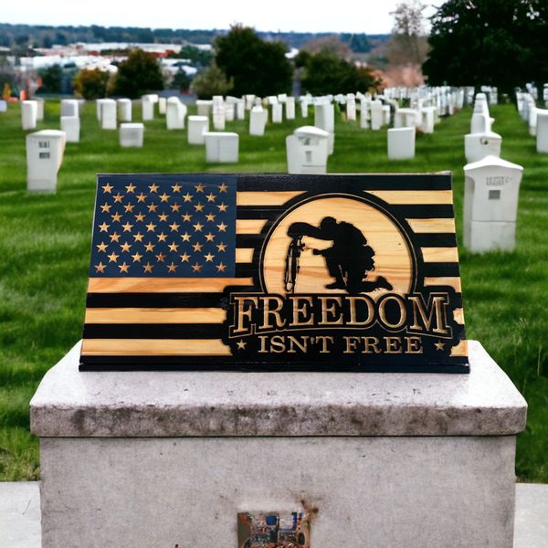 CNC Carved Flag with Soldier kneeling and the words "Freedom isn't Free"