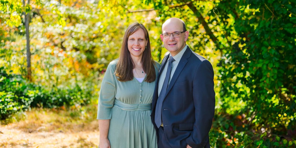 Smiling couple outdoors in autumn.