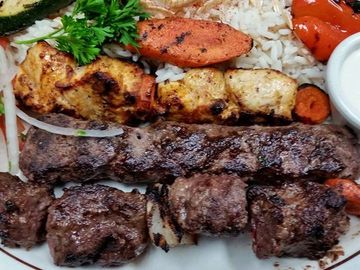 Kabob Combo beside rice and vegetables.