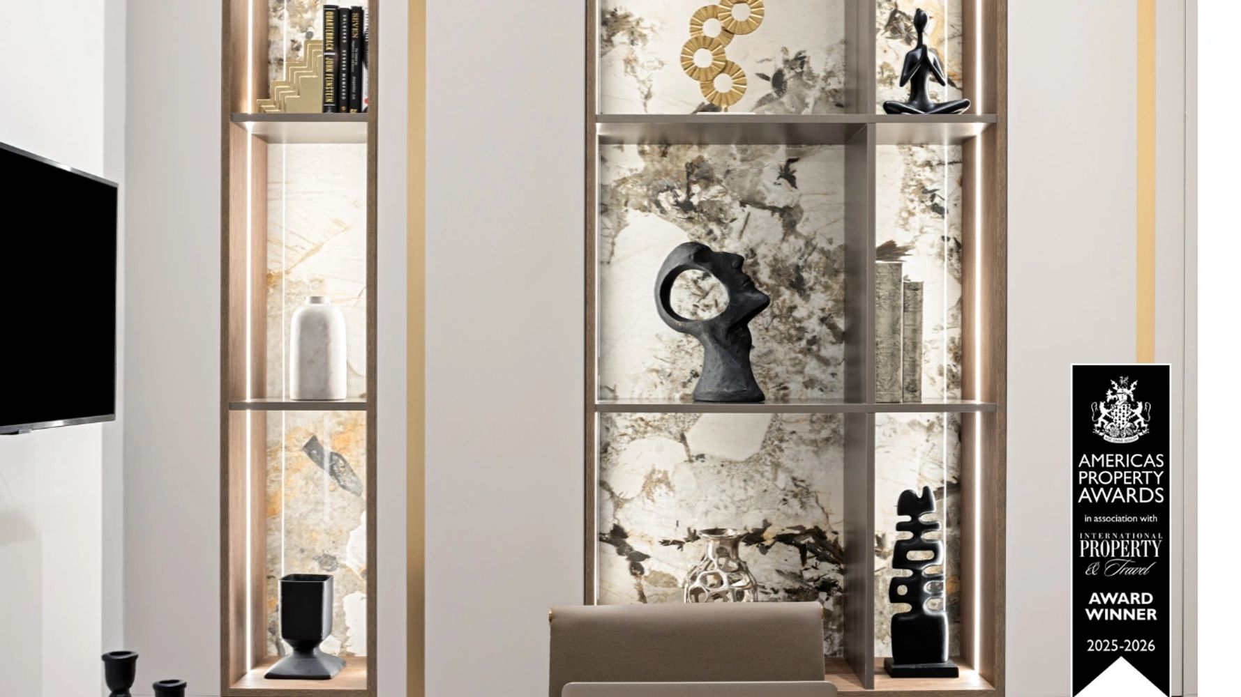 Modern shelf with artistic sculptures and award winner sign.