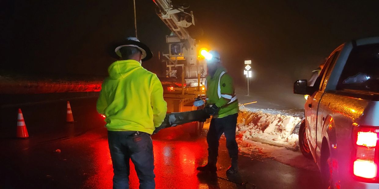 Red Rover rebuilding poles during storm response in Michigan, 2005.