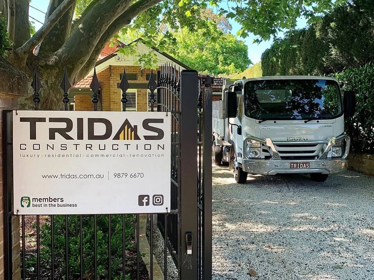 Tridas Construction entrance with a company truck parked inside.