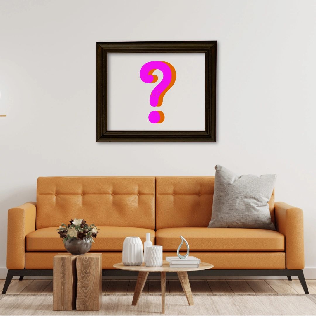 Modern living room with orange sofa and framed question mark art.