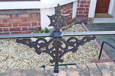 Decorative wrought iron fence with an ornate star-shaped finial.