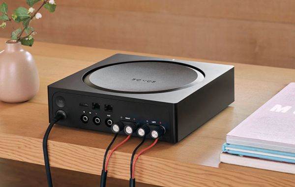 Sonos audio device on a wooden table.
