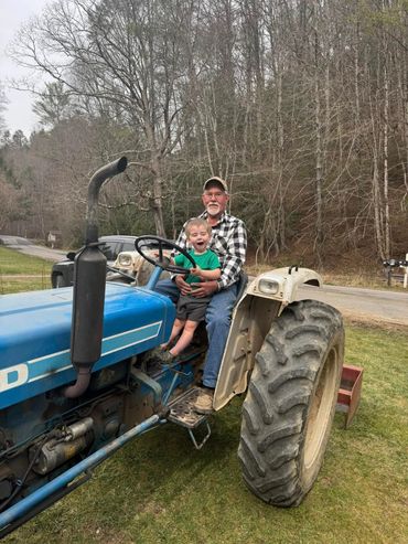 Donald and his grandson Malley hard at work on the tractor at CRI Headquarters. A heartwarming momen