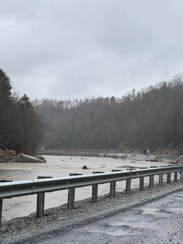 Reflecting on the serene river bend, imagining the peaceful beauty it once held before the storm's i