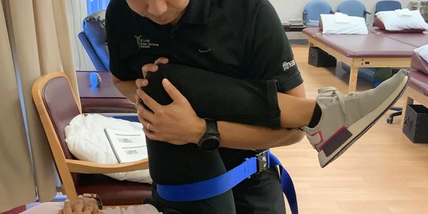 A doctor of physical therapy doing manual therapy to a patient to help her improve her health.