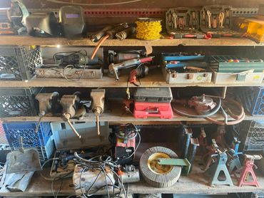 Organized workshop shelves with various tools and equipment.