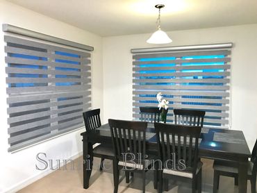 Modern dining room with dark wooden furniture and gray horizontal blinds.