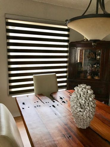 Rustic dining room with a unique ceramic centerpiece on a wooden table.